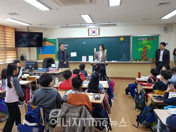 한국동서발전 직원이 울산초등학교학생들에게 교통안전용품 옐로카드를 설명하고 있다.