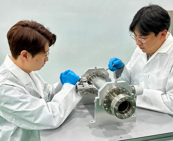 (주)큐빔솔루션 정봉기 대표(오른쪽)가 핵융합 기반 소형 중성자 발생 장치를 조립하고 있다.